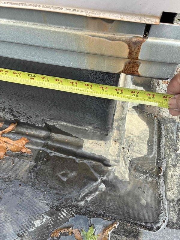 Conducted site evaluation of existing Carrier rooftop package unit on commercial property to provide replacement estimate. Unit exhibited significant deterioration including heavily soiled condenser coil with accumulated grime and debris, extensive rust staining and corrosion on evaporator coil section, and compromised condensate drainage with visible moisture damage patterns. Measured existing unit dimensions at approximately 48 inches to ensure proper replacement sizing. Noted deteriorated roofing membrane beneath unit with water damage and multiple penetrations requiring coordination during changeout. Documented equipment condition through photographic evidence showing corroded components, clogged drain pan with organic debris buildup, and weathered refrigerant lines. Prepared comprehensive replacement proposal for new rooftop package unit installation including necessary curb modifications and roof membrane repairs at equipment location.