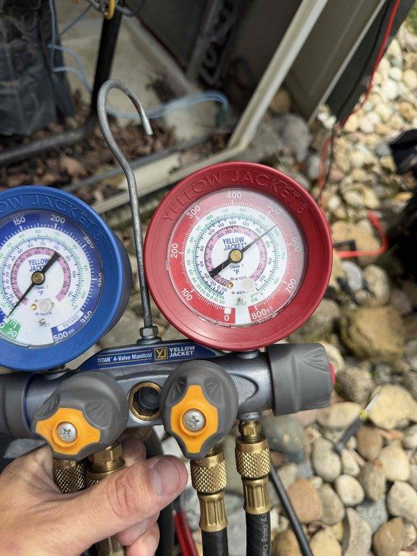 # No Cooling - Bedroom Unit

Responded to no cooling complaint on bedroom mini-split system. Upon arrival, found unit running but failing to maintain setpoint temperature. Connected manifold gauges to service ports and verified refrigerant pressures and temperatures. System showed low suction pressure indicating potential refrigerant undercharge or restriction. Used clamp meter to measure compressor amperage draw, recording 19.2 amps, which fell below manufacturer specifications for ambient conditions. Diagnosed system as undercharged due to refrigerant leak. Recommended leak detection service and proper refrigerant recharge to restore cooling capacity. Unit left in current operating state pending customer approval for additional repairs.