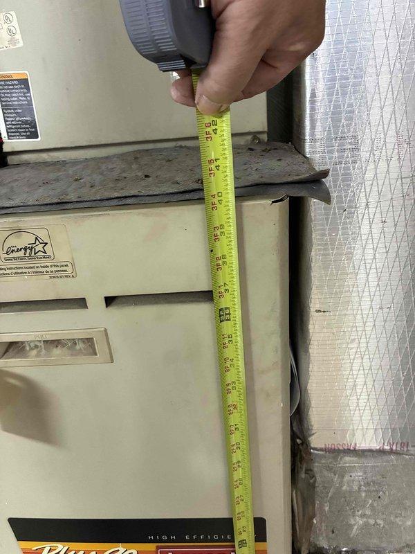 Conducted commercial site assessment for replacement of two HVAC systems. Evaluated existing equipment including Comfortmaker and Bryant units, documented equipment dimensions and clearances for proper sizing of replacement systems, and assessed ductwork configuration including flexible and rigid duct connections. Photographed existing installations showing previous coil installation work and equipment labeling to ensure accurate quoting for complete system replacements.