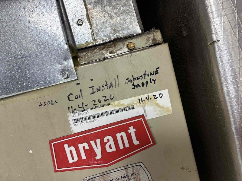 Conducted commercial site assessment for replacement of two HVAC systems. Evaluated existing equipment including Comfortmaker and Bryant units, documented equipment dimensions and clearances for proper sizing of replacement systems, and assessed ductwork configuration including flexible and rigid duct connections. Photographed existing installations showing previous coil installation work and equipment labeling to ensure accurate quoting for complete system replacements.