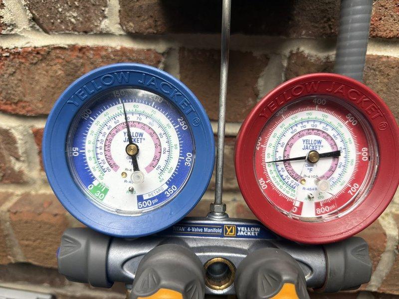 Responded to service call for recently installed HVAC unit experiencing repeated refrigerant loss. Upon arrival, connected manifold gauges to assess system pressures and confirmed unit was low on refrigerant again following recent recharge. Performed comprehensive leak search on refrigeration circuit and identified significant corrosion and deterioration on copper refrigerant line, with visible pitting, green oxidation, and surface degradation indicating active leak point. Documented corroded section with photos showing compromised pipe integrity. Advised that corroded refrigerant line requires replacement to provide permanent solution, as repeated refrigerant additions are not viable long-term fix given extent of pipe corrosion and active leak.