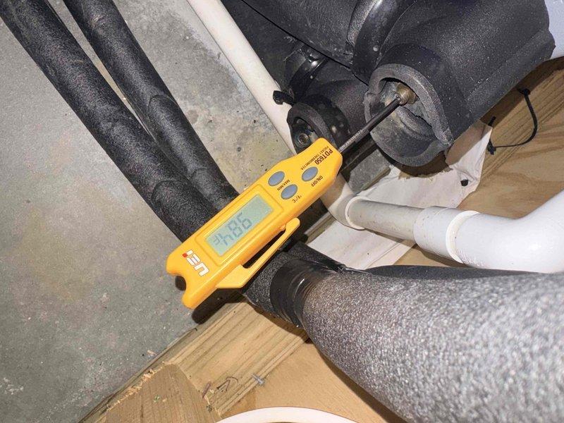 Completed annual cooling maintenance on residential HVAC system. Performed diagnostic testing of refrigerant lines using digital meter, inspected foam-insulated line sets and PVC condensate drainage for proper operation. Inspected evaporator coil and heat exchanger, noting dust and debris accumulation on finned surfaces and U-bend tubes; system components showing normal wear consistent with regular operation. All measurements recorded within acceptable parameters, and membership renewal processed on-site.