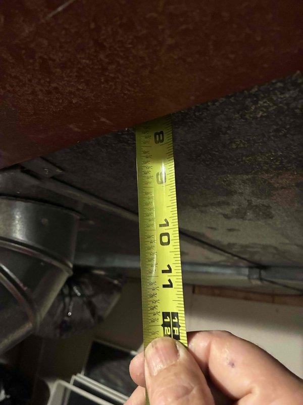 Conducted on-site assessment for complete HVAC system replacement. Measured existing ductwork dimensions and clearances in mechanical space, documenting 8-9 inch duct runs and vertical clearances between floor joists to ensure proper equipment fitment for new installation.