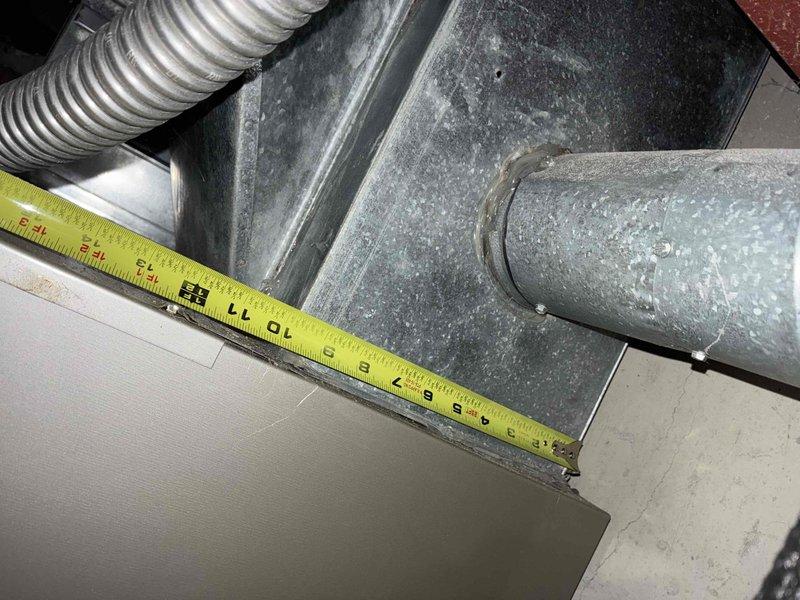 Conducted on-site assessment for complete HVAC system replacement. Measured existing ductwork dimensions and clearances in mechanical space, documenting 8-9 inch duct runs and vertical clearances between floor joists to ensure proper equipment fitment for new installation.