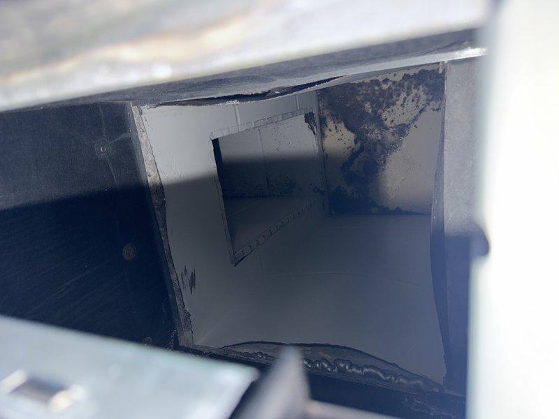 Responded to service call for moisture and condensation accumulation around furnace system in garage area. Upon inspection, discovered significant water staining and discoloration inside the air handler unit, indicating ongoing moisture intrusion. Examined the PVC condensate drain system and air handler cabinet for proper drainage function and potential leak sources. Documented existing water damage on interior cabinet surfaces with evidence of prolonged moisture exposure. Identified condensate management issue requiring attention to prevent further damage to equipment and surrounding area.