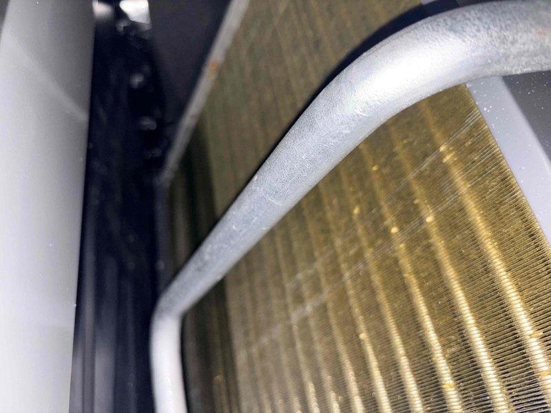 Completed annual cooling maintenance on residential air conditioning system. Performed comprehensive inspection of indoor evaporator coil, confirming proper fin condition and airflow through heat exchanger assembly. Inspected outdoor condenser unit, verified protective grille and wire grid framework securely mounted with sensor and electrical components properly attached. System operating within normal parameters with all components functioning as designed.