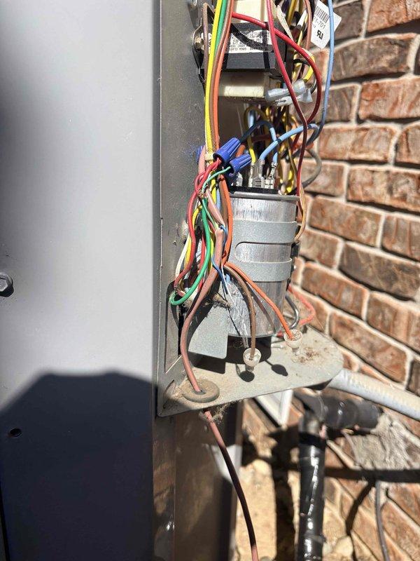 Responded to no cooling complaint on residential HVAC system less than 10 years old. Inspected outdoor condensing unit and low-voltage control wiring at exterior electrical junction box, verifying all thermostat wire connections and power supply to unit. System evaluated and found all electrical connections secure with proper color-coded wiring configuration intact.
