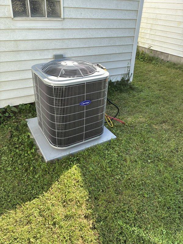 Completed full HVAC system installation including Carrier 26SCA424N003 single-stage air conditioner with R-454B refrigerant, CVAVA2414XMA evaporator coil, 58SB0B070M14--12 single-stage gas furnace with 70,000 BTU capacity, and TSTATCCEWF-01 Wi-Fi smart thermostat. Outdoor condenser unit positioned on concrete pad with proper clearances, indoor coil installed in air handler plenum, furnace mounted and vented per code requirements, and thermostat configured with Wi-Fi connectivity and system parameters. All equipment tested for proper operation, refrigerant charge verified, gas connections leak-checked, condensate drainage confirmed, and system cycling through heating and cooling modes successfully.