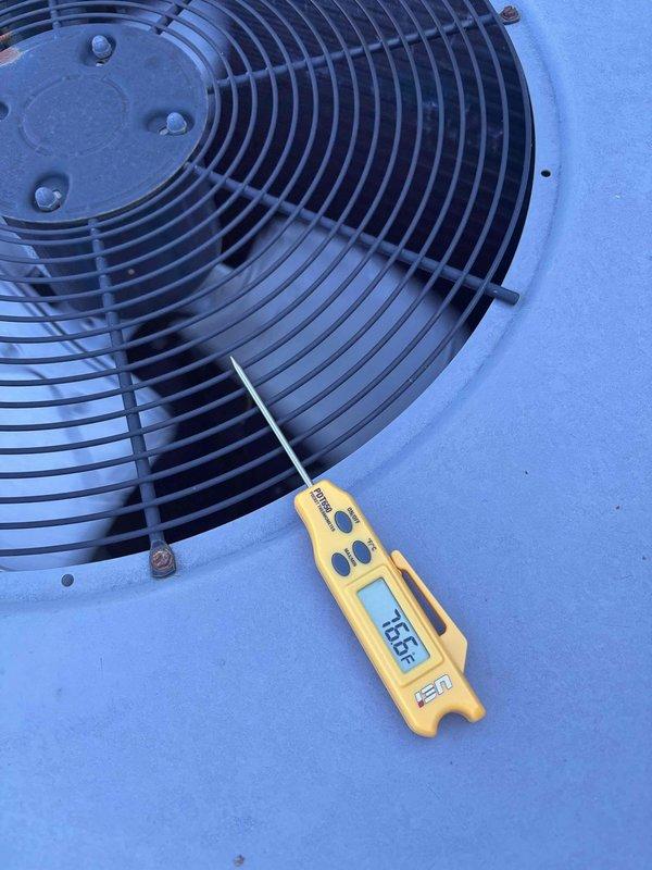 Responded to commercial no cooling call where building temperature was 75° with thermostat set to 70°. Upon arrival, confirmed system was running but not producing cold air. Performed diagnostic evaluation of outdoor condenser unit, measuring discharge air temperature at 135.5° at the fan grille, indicating compressor operation. Inspected electrical connections at exterior junction box and refrigerant line set. System requires further troubleshooting to identify root cause of insufficient cooling capacity.