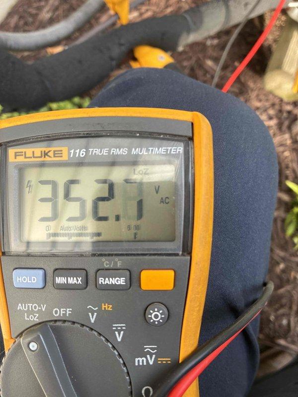 Completed scheduled cooling maintenance visit that was rescheduled due to weather conditions. Technicians performed comprehensive system evaluation of mini split installation, verifying electrical parameters with multimeter readings showing 352.1V AC, and inspecting insulated refrigerant line sets and ductwork components for proper installation and operational integrity.