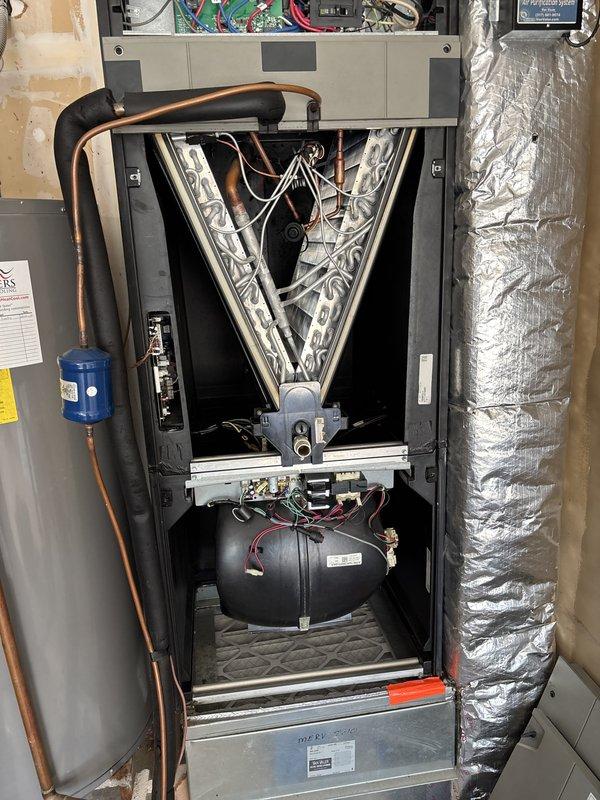 Completed scheduled heating maintenance on residential HVAC system, performing comprehensive tune-up inspection of air handler unit with internal components including refrigerant lines, pressure tank, and filter-drier. Inspected drainage system as requested and noted dust accumulation on supply register requiring attention during future maintenance visit.