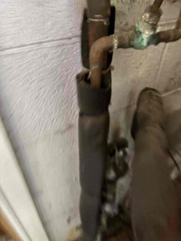 Arrived to perform scheduled cooling maintenance but confirmed property does not have an air conditioning system installed. Per customer communication, converted visit to heating system inspection instead. Inspected boiler system, expansion tank, and associated copper piping; documented existing plumbing infrastructure showing age-related corrosion on iron components and verdigris buildup on copper fittings, though all components remain functional at this time.