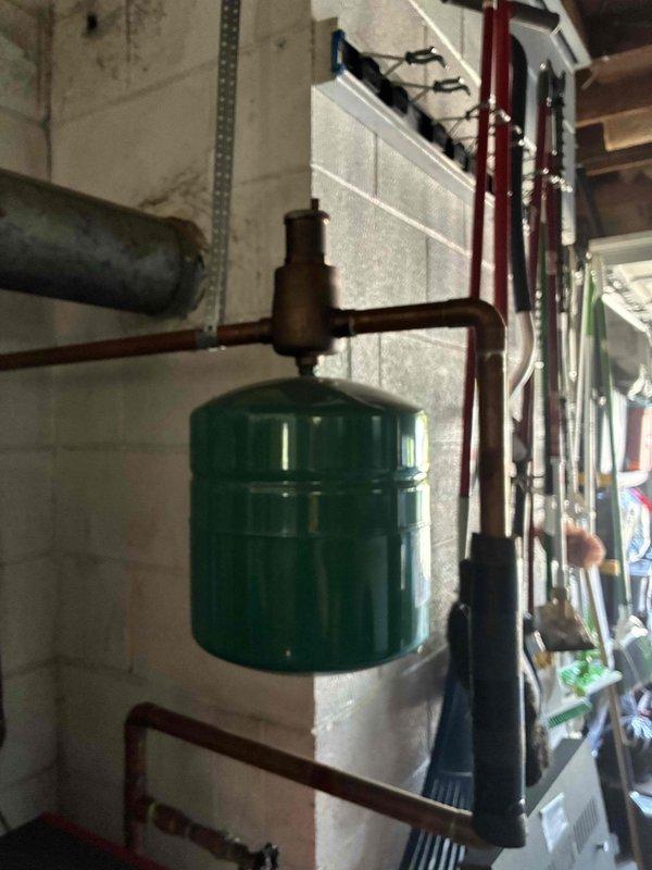Arrived to perform scheduled cooling maintenance but confirmed property does not have an air conditioning system installed. Per customer communication, converted visit to heating system inspection instead. Inspected boiler system, expansion tank, and associated copper piping; documented existing plumbing infrastructure showing age-related corrosion on iron components and verdigris buildup on copper fittings, though all components remain functional at this time.