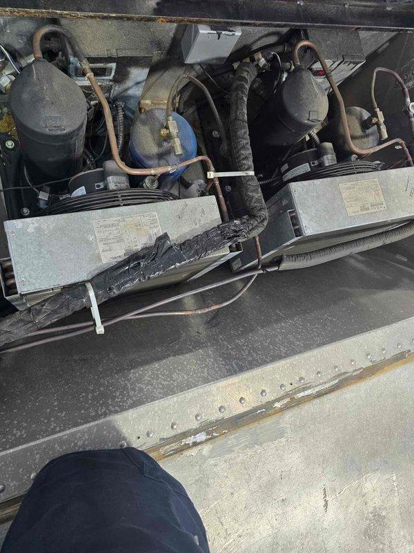 Responded to service call for three non-operational mini split systems installed in a racing trailer. Performed diagnostic inspection of all units, accessing evaporator coils and examining condenser components including compressors, refrigerant lines, and accumulator tanks. Documented equipment condition through photographic evidence showing internal coil assemblies, copper line sets with insulation, and outdoor condenser units with visible weathering and dirt accumulation on surfaces.