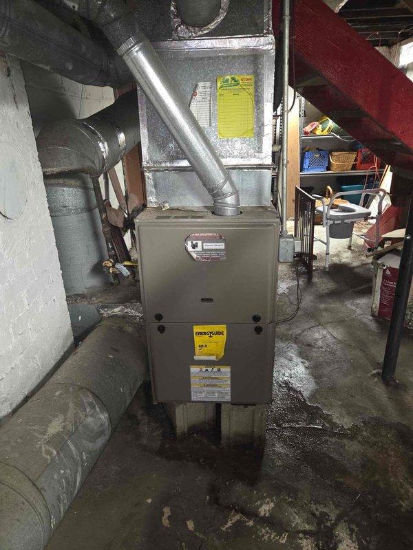 Performed comprehensive site evaluation for HVAC system replacement in basement utility area. Documented existing furnace and air handler configuration, including plenum assembly and ductwork layout. Measured existing gas line diameter to verify compatibility with proposed replacement equipment. Assessed installation space constraints, noting concrete floor moisture conditions, structural beam clearances, and accessibility for equipment removal and installation. Photographed current system specifications and equipment labels to determine proper sizing requirements for replacement unit quotation.