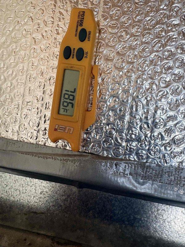 Responded to no cooling call and performed diagnostic evaluation of residential air conditioning system. Verified thermostat operation showing 75°F setpoint in cooling mode with system actively running. Measured supply air temperature at ductwork registering 79.5°F, indicating insufficient cooling performance requiring further system assessment and potential refrigerant charge verification or compressor evaluation.