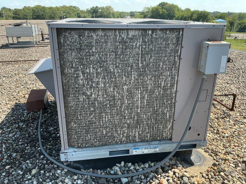 Completed comprehensive tune-up maintenance on Bryant commercial rooftop unit model 579FEV240360AHHD (serial #0303F11922) per checklist requirements. Performed full system inspection, documented all equipment data plate information with photographs as requested, and verified unit operational status. Unit found in satisfactory working condition with filter/coil assembly showing normal environmental accumulation for rooftop installation.