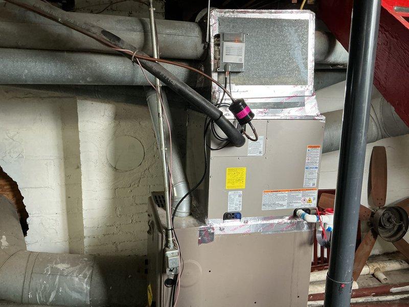 Completed full HVAC system installation including Carrier 26SCA430N003 single-stage air conditioner condenser unit, CVAVA3621XMA evaporator coil, and TSTATCCEWF-01 Wi-Fi smart thermostat. Installed outdoor condenser unit on pad at exterior foundation, ran refrigerant line set through basement wall, and mounted evaporator coil above existing air handler in mechanical room. Connected electrical service with exterior disconnect, ran low-voltage thermostat wiring, evacuated refrigerant lines to proper vacuum levels, and charged system to manufacturer specifications using manifold gauges. Configured and connected smart thermostat to Wi-Fi network, verified all electrical connections at junction box and conduit, and tested system operation through complete cooling cycle. All equipment covered under manufacturer's 10-year limited parts warranty with thermostat including extended 5-year connected parts warranty when maintained on Wi-Fi. System operating within normal parameters with proper air