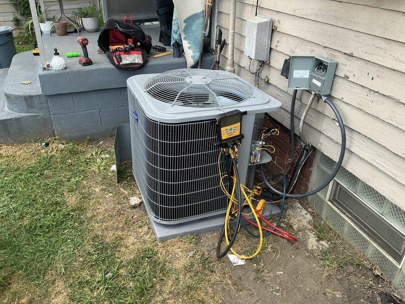 Completed full HVAC system installation including Carrier 26SCA430N003 single-stage air conditioner condenser unit, CVAVA3621XMA evaporator coil, and TSTATCCEWF-01 Wi-Fi smart thermostat. Installed outdoor condenser unit on pad at exterior foundation, ran refrigerant line set through basement wall, and mounted evaporator coil above existing air handler in mechanical room. Connected electrical service with exterior disconnect, ran low-voltage thermostat wiring, evacuated refrigerant lines to proper vacuum levels, and charged system to manufacturer specifications using manifold gauges. Configured and connected smart thermostat to Wi-Fi network, verified all electrical connections at junction box and conduit, and tested system operation through complete cooling cycle. All equipment covered under manufacturer's 10-year limited parts warranty with thermostat including extended 5-year connected parts warranty when maintained on Wi-Fi. System operating within normal parameters with proper air