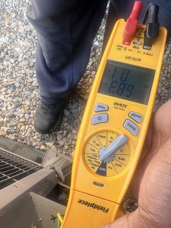 Performed scheduled preventative maintenance tune-up on residential air conditioning condenser unit. Conducted comprehensive system inspection including electrical testing with digital multimeter to verify proper voltage and amperage readings, inspected condenser fan operation and motor function, examined fan grille and housing for damage or debris, and confirmed unit cleanliness and overall operational status. System found to be in good working condition with no immediate repairs required.