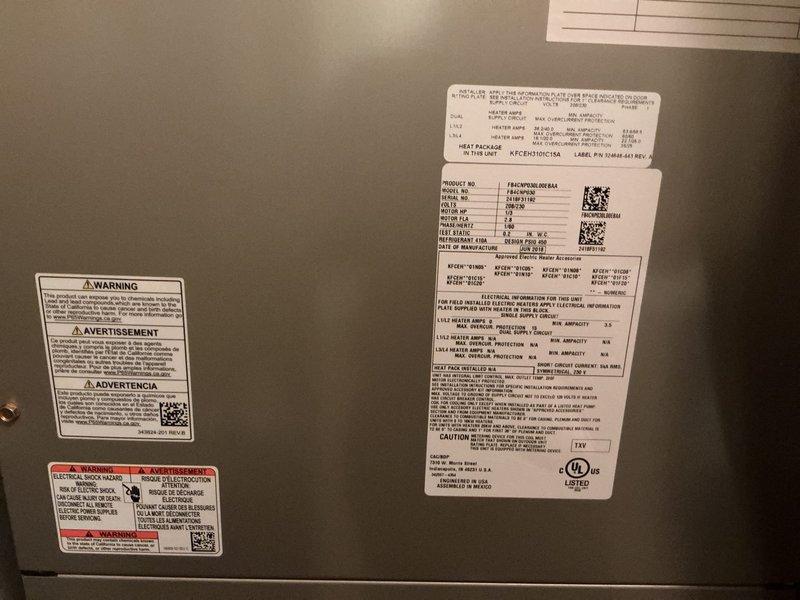 Responded to call for water leak near furnace with significant pooling requiring towels. Upon arrival, inspected Carrier HVAC unit located in utility closet alongside laundry equipment. Examined condensate drain system including white PVC piping running across floor area. Diagnosed source of water leak as blocked or improperly draining condensate line from air handler. Cleared obstruction from drain line, verified proper drainage flow, and tested system operation to ensure leak was resolved. Unit returned to normal operation with no further water discharge observed.