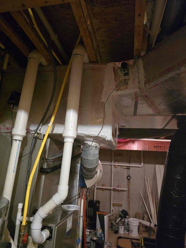 Relocated two supply ducts that were incorrectly positioned on the wrong side of the zone damper to ensure proper airflow control and system efficiency. Sealed all plenum connections and seams with mastic to eliminate air leakage and improve system performance per maintenance agreement specifications.
