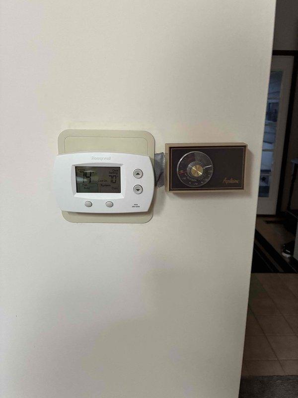 Conducted on-site assessment of existing HVAC system and water heater for complete system replacement estimate. Documented current equipment configuration including furnace, humidifier, water heater, ductwork, and dual thermostat setup (digital Honeywell and analog unit) to provide comprehensive replacement proposal for full system upgrade.