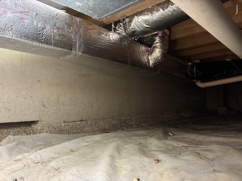 Completed warranty return visit to crawl space to reseal damaged HVAC ductwork insulation. Accessed crawl space and inspected flexible ductwork with reflective foil-faced insulation that showed multiple tears and compromised sections exposing underlying material. Resealed all damaged areas of duct insulation to restore proper vapor barrier and thermal efficiency of the system.