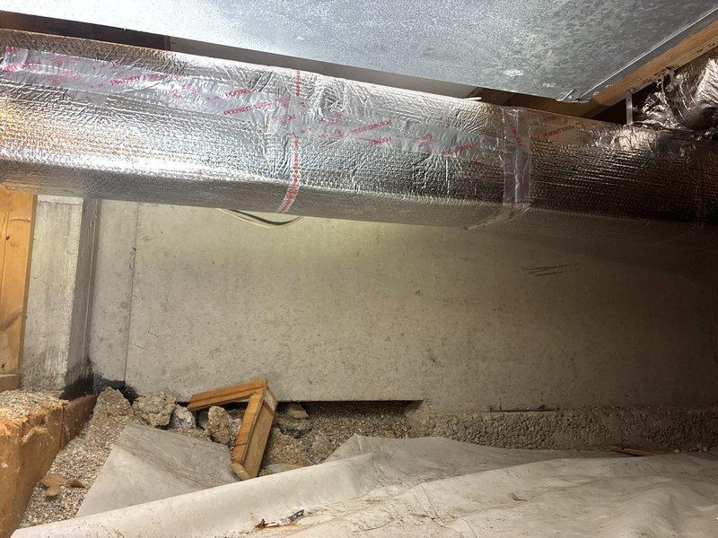 Completed warranty return visit to crawl space to reseal damaged HVAC ductwork insulation. Accessed crawl space and inspected flexible ductwork with reflective foil-faced insulation that showed multiple tears and compromised sections exposing underlying material. Resealed all damaged areas of duct insulation to restore proper vapor barrier and thermal efficiency of the system.