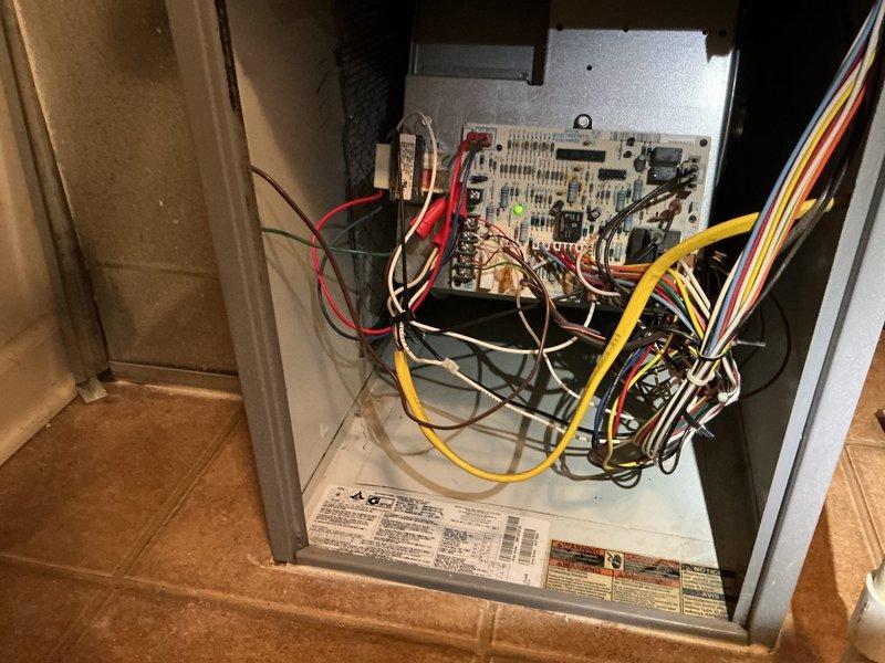 Responded to callback for burning odor complaint following recent maintenance and service visit. Conducted thorough inspection of HVAC system including control board, wiring connections, and refrigerant lines. Examined all electrical components, terminal connections, and insulation materials for signs of overheating, arcing, or deterioration that could produce odors. Verified proper operation of blower motor, capacitor, and control board circuits. Documented system condition with photos showing wiring configuration, control board assembly, and insulation at refrigerant line connections. All components found operating within normal parameters with no visible signs of burning or thermal damage detected during inspection.