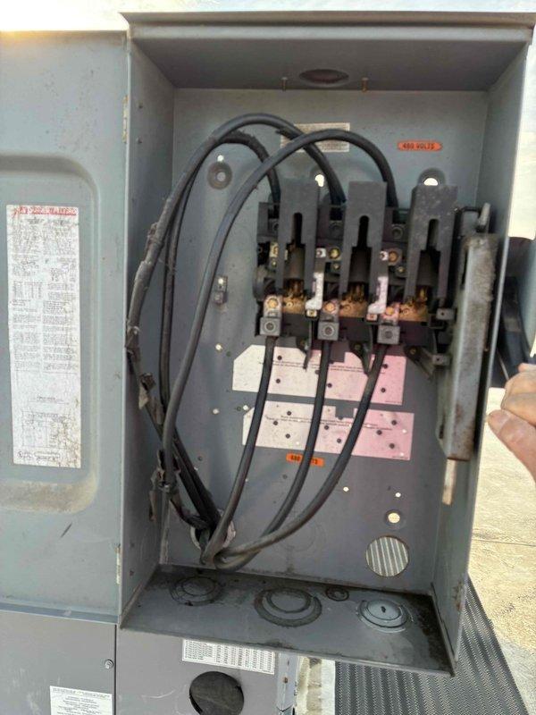 Conducted site assessment and prepared estimate for replacement of two 20-ton rooftop HVAC units at commercial facility. Inspected existing equipment including electrical disconnects showing signs of oxidation and wear on copper contact points, documented rooftop access and mounting conditions, and photographed units with water-stained membrane roofing around installations to provide comprehensive quote for full system replacement.