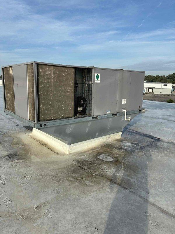 Conducted site assessment and prepared estimate for replacement of two 20-ton rooftop HVAC units at commercial facility. Inspected existing equipment including electrical disconnects showing signs of oxidation and wear on copper contact points, documented rooftop access and mounting conditions, and photographed units with water-stained membrane roofing around installations to provide comprehensive quote for full system replacement.