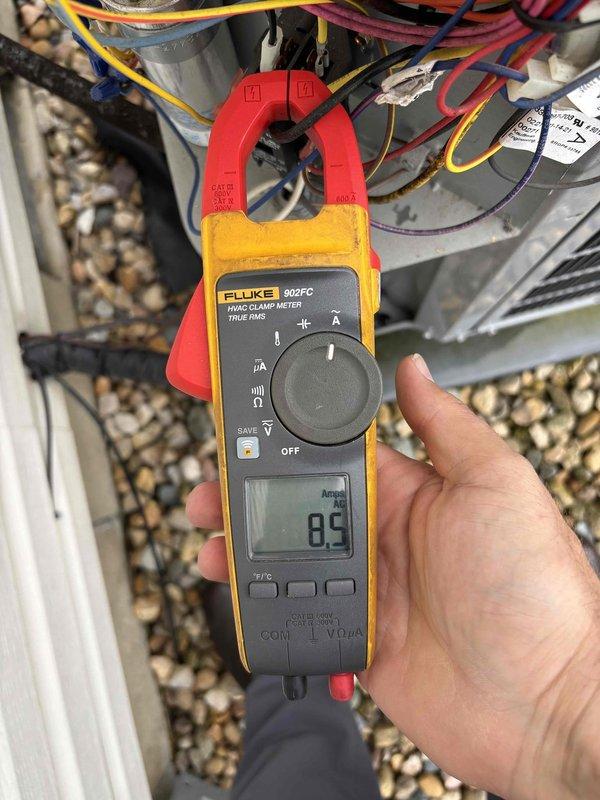 Performed comprehensive tune-up on air handler and heat pump system. Conducted electrical diagnostics on outdoor unit, measuring compressor amperage at 8.5 amps using clamp meter to verify proper motor operation and system performance. Recorded temperature readings at 97.9°F using infrared thermometer to assess system efficiency and confirm proper heat pump operation during preventive maintenance inspection.
