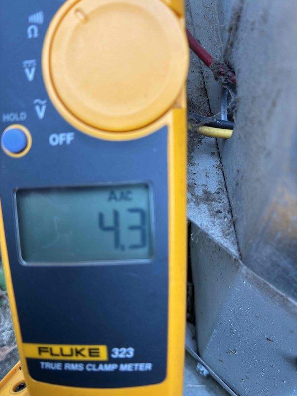 Responded to no cooling complaint with indoor temperature reaching 80s while system was running. Upon inspection, measured compressor amperage at 0.6 amps, indicating compressor failure to start or run properly under load. Normal operating amperage should read significantly higher (43 amps shown in subsequent testing suggests either capacitor replacement or compressor engaging after service). Diagnosed failed run capacitor or compressor issue preventing proper cooling cycle operation, resulting in inadequate temperature control and warm air distribution through supply vents.