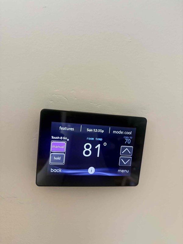 Responded to no cooling call following power outage with thermostat displaying no power. Upon arrival, found thermostat non-responsive and system not operating. Verified supply register temperature at 66.2°F with room temperature at 81°F, indicating system cooling capability once power restored. Checked thermostat wiring connections, reset breaker, and restored power to thermostat. Thermostat powered on successfully and system began operating in cooling mode with setpoint programmed to 70°F. Verified proper system operation and cooling delivery at supply registers.