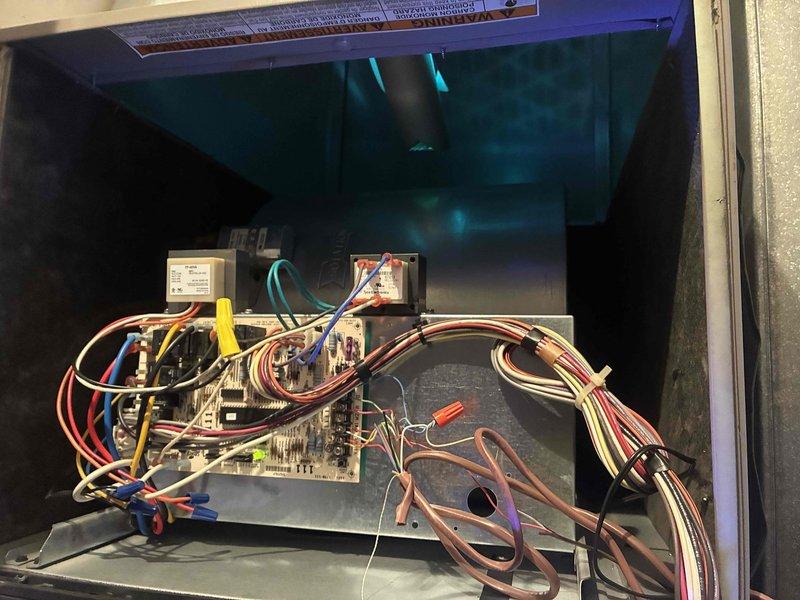 Completed scheduled heating maintenance on residential HVAC system. Performed comprehensive inspection of air handler unit, including examination of electrical components, control board, transformers, and wiring connections. Used Fluke 323 digital clamp meter to verify electrical current readings, which measured 0.6 amps during testing. Inspected all wire connections throughout the compartment, including bundled multi-colored wiring harnesses and individual circuit runs. Verified proper operation of dual transformer units mounted in upper compartment. All electrical connections found secure with no signs of overheating or deterioration. Control board functioning within normal parameters. System operational and ready for heating season.