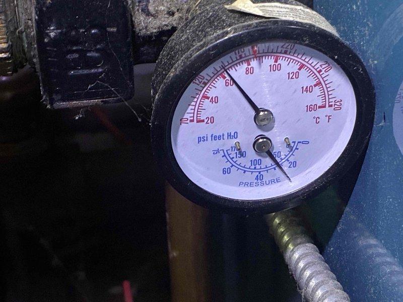 Completed scheduled heating-only maintenance service on residential boiler system. Inspected and verified pressure/temperature gauge readings showing normal operating parameters at approximately 80°F, checked system components including copper tubing with finned coils, and performed routine maintenance procedures to ensure proper operation for the upcoming heating season.