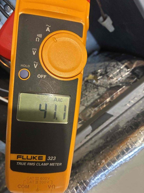 Completed comprehensive 2026 heating maintenance first service on residential HVAC system. Performed electrical diagnostics using clamp meter, recording 411 AAC amperage reading to verify proper system operation and current draw within manufacturer specifications. Inspected control board circuitry, verified all terminal connections, assessed circuit breaker functionality, and confirmed all wiring connections were secure throughout the electrical control panel. System operating normally with all components functioning as designed.