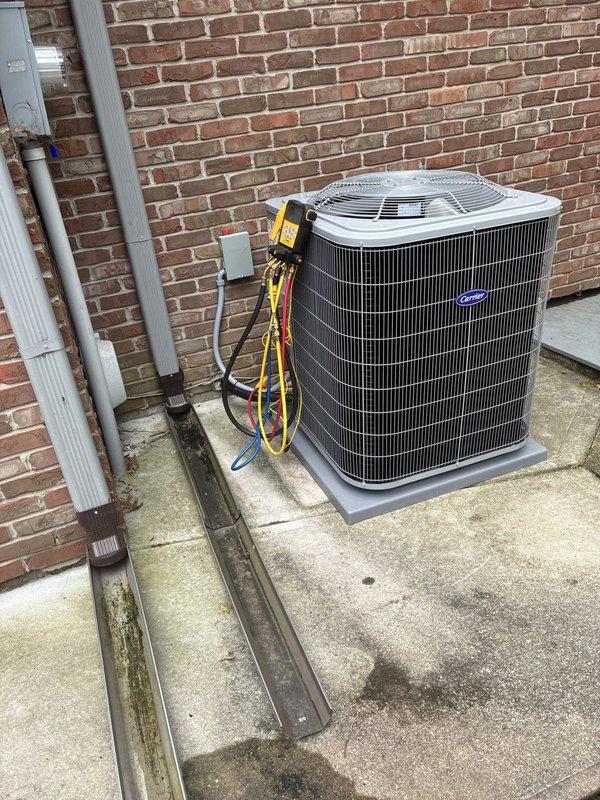 Completed full HVAC system installation consisting of Carrier Comfort Series equipment including 26SCA442N003 single-stage air conditioner, CVAVA4221XMA evaporator coil, and 58SB0B110M21-20 single-stage gas furnace. Installed outdoor condensing unit on existing concrete pad adjacent to structure, secured refrigerant line set and condensate drainage piping along exterior wall with proper mounting brackets, and connected electrical disconnect. Installed indoor evaporator coil and gas furnace, established refrigerant connections between outdoor and indoor components, and performed complete system startup procedures. Evacuated refrigerant lines to proper vacuum levels, charged system with R454B refrigerant to manufacturer specifications, and utilized Fieldpiece SMAN manifold gauges to verify operating pressures and temperatures. Measured and recorded system performance data including suction pressure at 1203 PSI, discharge pressure at 2133 PSI, superheat at 84°F, and subcooling at 110°F to
