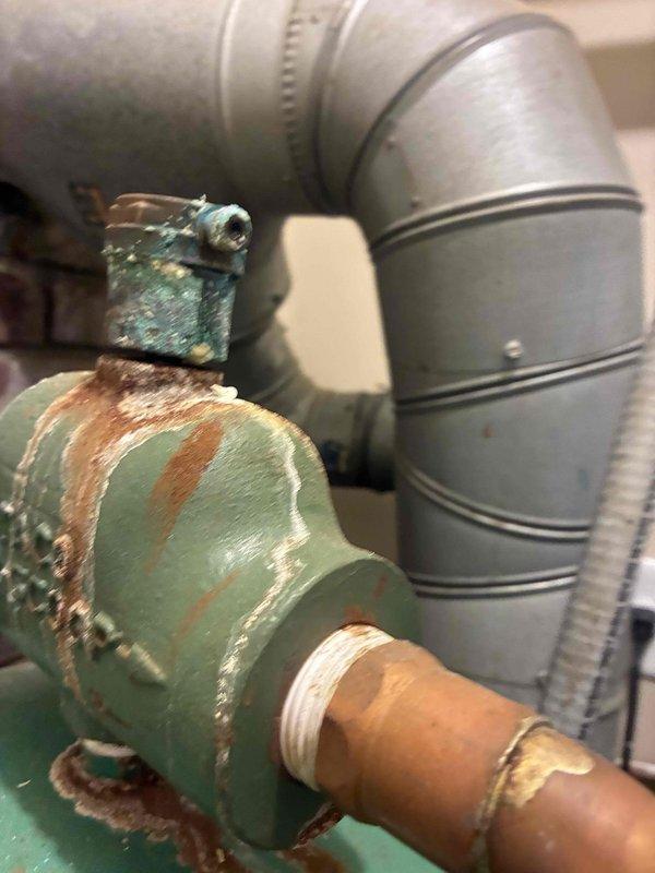 Responded to no-heat call for Burnham Series 2 gas boiler of unknown age. Upon inspection, found extensive corrosion on main supply piping and valve assembly, with deteriorated paint and significant rust buildup indicating prolonged moisture exposure. Evaluated system pressure and temperature readings via control gauge, assessed overall system condition, and documented corroded components requiring attention to restore proper operation and prevent future system failure.