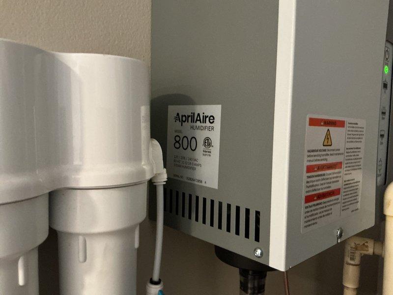 Following new HVAC system installation, discovered existing humidifier was non-operational and required replacement. Removed old humidifier unit and upgraded to AprilAire Model 800 steam humidifier with downflow installation kit to ensure proper humidity control for the residence. Completed all electrical connections, mounted unit to ductwork, installed condensate drain trap assembly with PVC piping, verified proper steam output, and tested system operation to confirm full functionality.