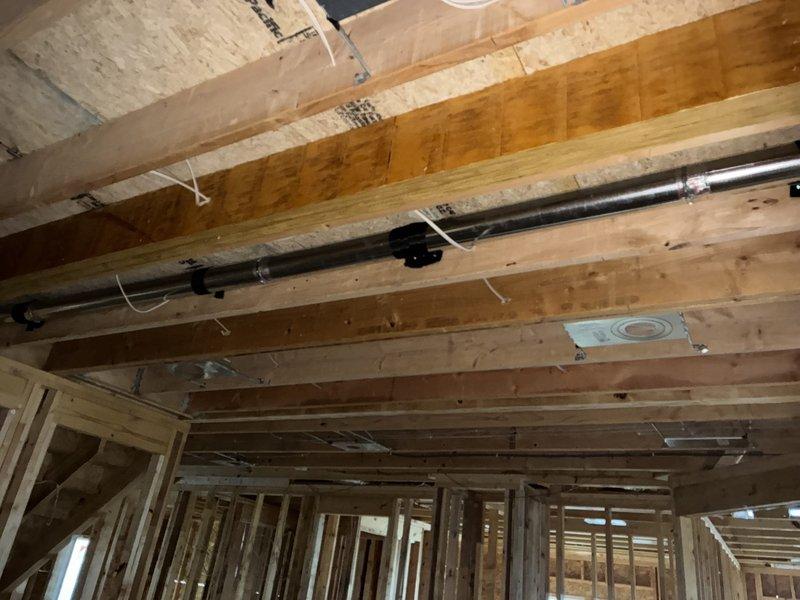 Completed installation of hose clamps on dryer vent ductwork and sealed all registers on the first floor to improve system efficiency and prevent air leakage. Work was performed in exposed framing areas with all components properly secured to structural members using appropriate mounting hardware and metal strapping.