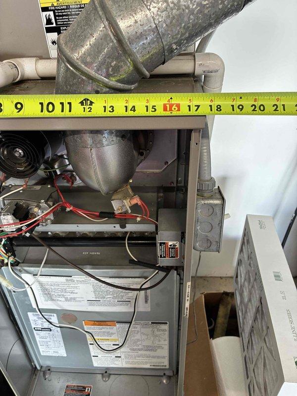 Performed system evaluation and documentation for HVAC replacement estimate. Assessed existing furnace unit and ductwork installation, noting aged cylindrical supply duct with visible deterioration and biological growth. Measured and documented duct dimensions and clearances using precision measuring equipment to determine replacement specifications. Photographed equipment configuration, mechanical connections, and spatial constraints within utility closet for accurate system sizing and installation planning. Determined that repair costs and unit age warranted full system replacement recommendation, with homeowner agreeing to proceed with comfort advisor consultation for replacement options.