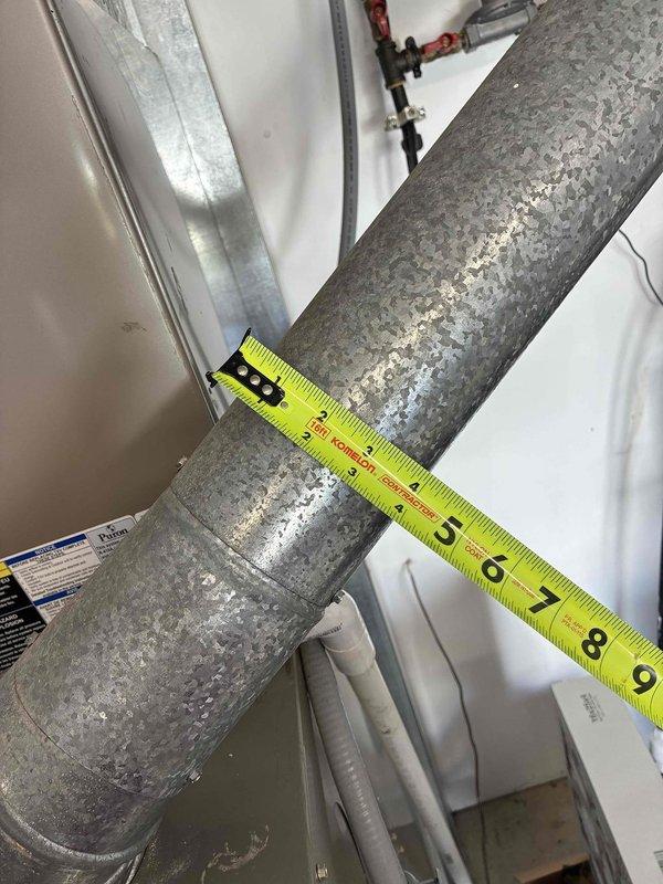 Performed system evaluation and documentation for HVAC replacement estimate. Assessed existing furnace unit and ductwork installation, noting aged cylindrical supply duct with visible deterioration and biological growth. Measured and documented duct dimensions and clearances using precision measuring equipment to determine replacement specifications. Photographed equipment configuration, mechanical connections, and spatial constraints within utility closet for accurate system sizing and installation planning. Determined that repair costs and unit age warranted full system replacement recommendation, with homeowner agreeing to proceed with comfort advisor consultation for replacement options.