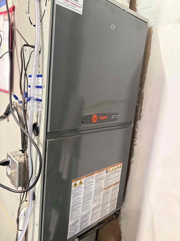 Completed routine heating system maintenance on Trane XV95 furnace. Performed comprehensive tune-up including inspection of all major components, burner assembly, heat exchanger, blower motor, and electrical connections. Verified proper operation of RGF REME HALO air purification system mounted in ductwork. Checked and tested humidifier system per customer request, confirmed proper functionality and settings. Inspected gas valve, pressure switch, ignition system, and flame sensor; all components operating within manufacturer specifications. Cleaned blower assembly and replaced air filter. Tested system startup and shutdown sequences, monitored temperature rise across heat exchanger, and verified proper airflow throughout system. Checked flue pipe connections and condensate drain for proper operation. System running efficiently with no issues detected; unit ready for heating season operation.