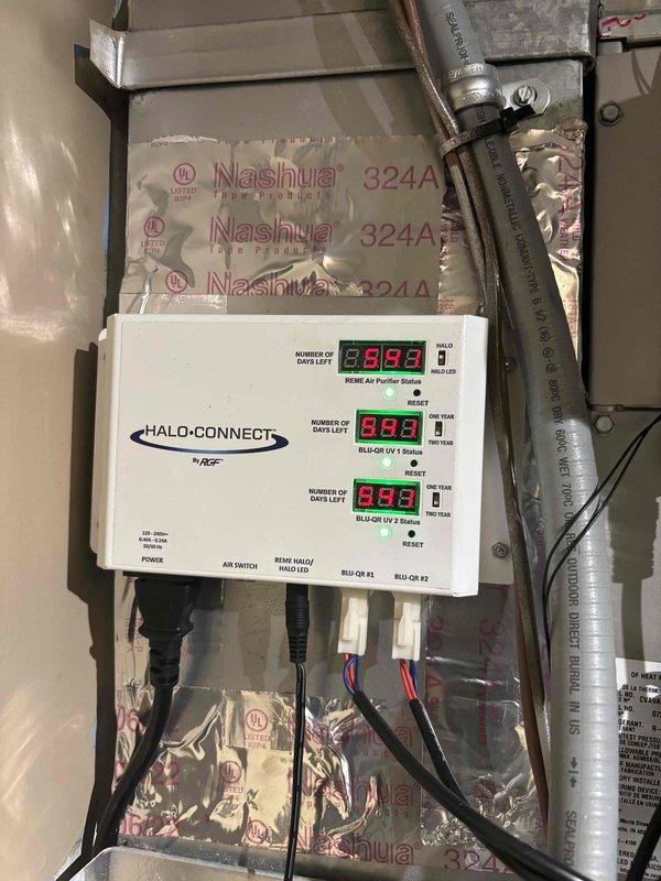 Completed scheduled heating maintenance on residential HVAC system. Inspected and verified operation of HALO-CONNECT air purification system with RE85E air purifier and dual BLUE-QII UV units, confirming all status displays and indicator lights functioning properly. Performed electrical diagnostics using digital multimeter, recording voltage readings of 465V to verify proper system operation and electrical integrity.