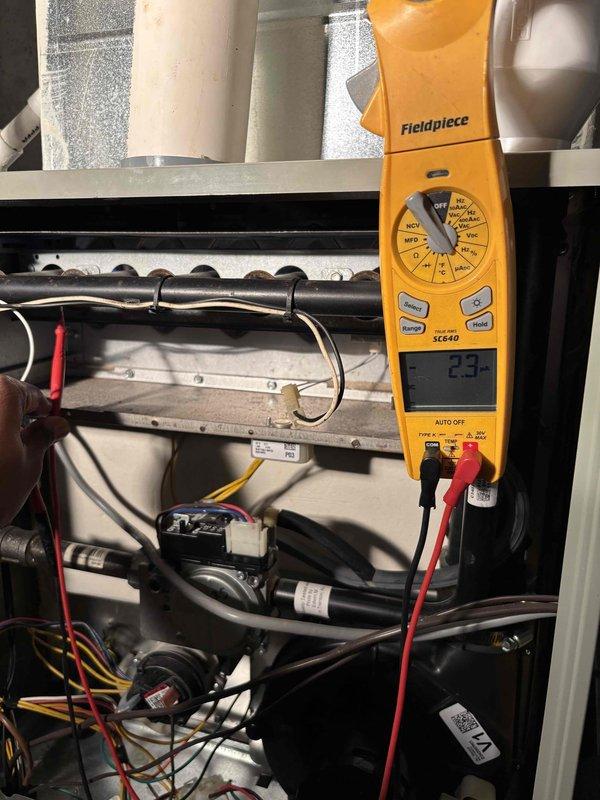 Performed scheduled preventive maintenance on the geothermal heat pump system, including electrical diagnostics with a True RMS clamp meter to measure amperage draw and verify proper operation of the equipment's control and power wiring. Inspected the interior cabinet, wiring harnesses, burner and gas valve assembly, and surrounding components for signs of frost, corrosion, or damage, finding none, and confirmed the system was operating normally at the conclusion of the visit.