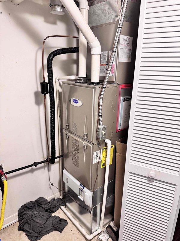 Performed a seasonal heating tune-up on a Carrier vertical gas furnace with condensate drain and PVC venting, inspecting the unit, gas and electrical connections, and condensate line. Verified supply duct temperature of approximately 136°F using a digital thermometer, confirming proper heat output, and noted no visible rust, frost, or damage. Advised the customer of available maintenance plan options.