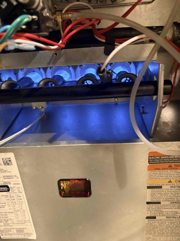 Responded to a no-heat call on a newly installed gas furnace. Inspected the gas valve assembly and wiring harness, confirming secure terminal connections and proper valve operation. Verified ignition sequence and burner operation, with stable blue flame observed across all burners and normal flame visibility at the sight glass. System restored to normal heating operation with no further issues found.