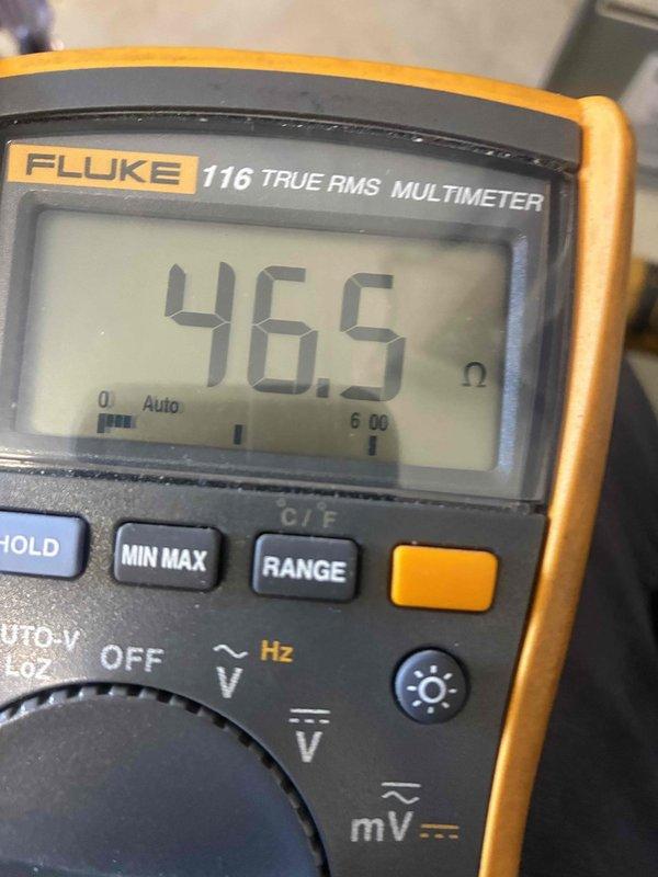 Performed seasonal heating system maintenance and electrical diagnostics, using a true-RMS multimeter to verify component resistance (46.5 Ω reading) and a clamp meter to measure operating amperage draw (2.6 A AC) on the unit. Electrical readings were documented to confirm components are operating within normal parameters and the system is ready for the heating season.